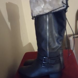 Knee high leather fur trim boots.